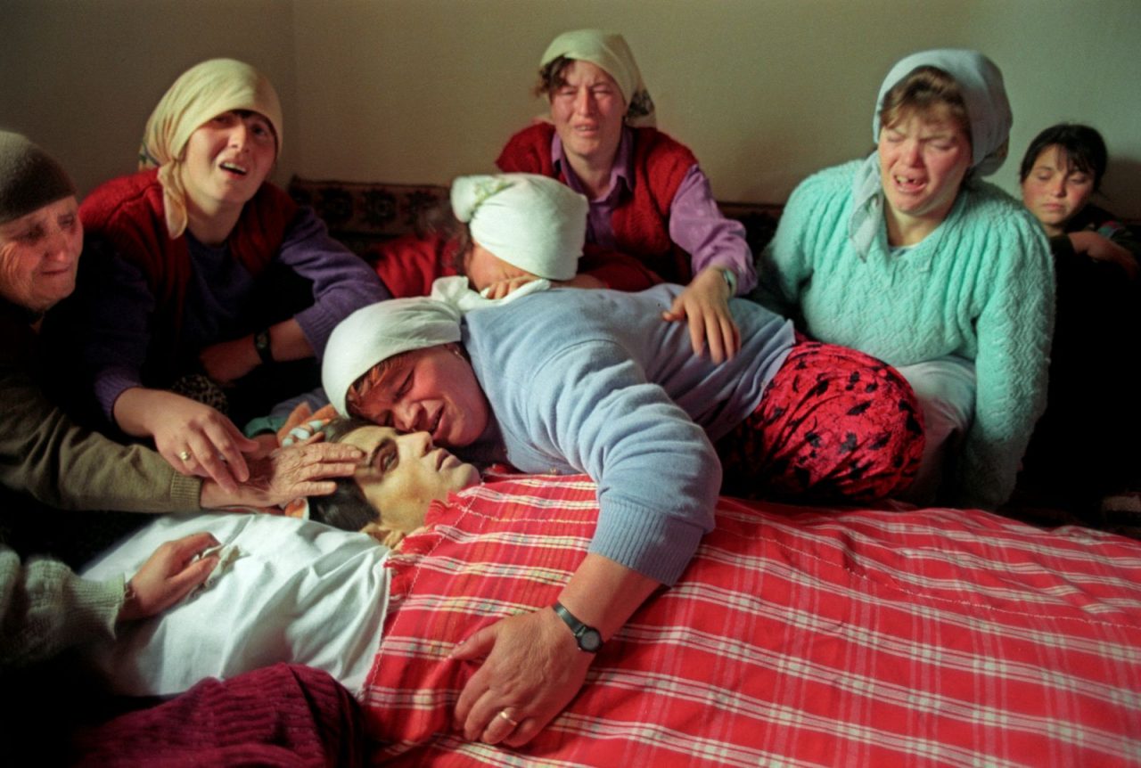 Women from the Kosovo village of Dragobil mourn Ali Pacarizi, killed by Serbian forces in 1998. Photo: Alan Chin.